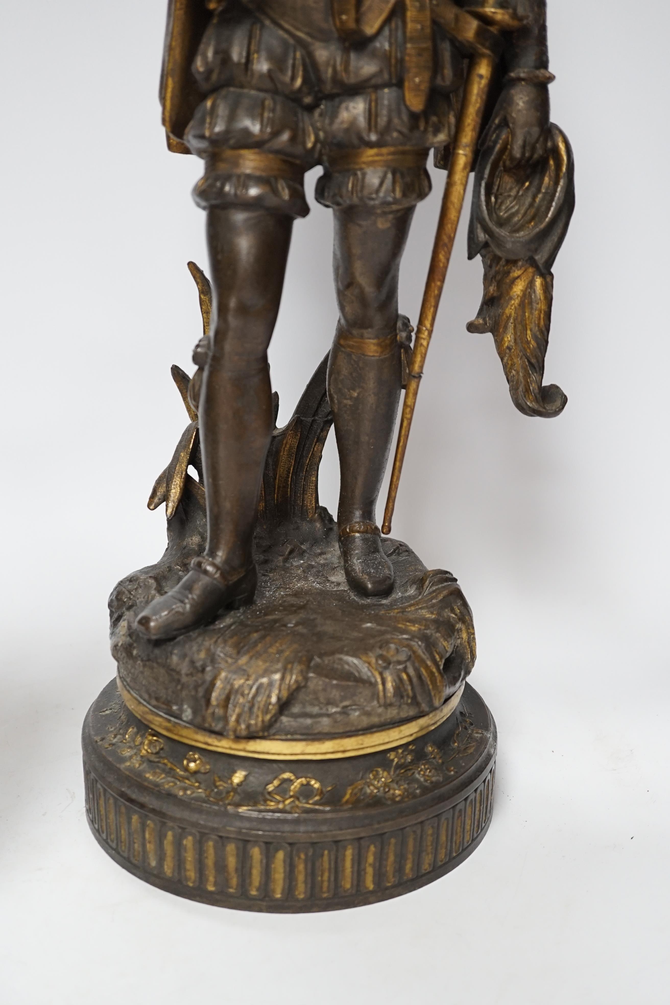 A 19th century parcel gilt and bronzed spelter figure of a cavalier, together with a Florentine style bronze ewer, 49cm high (the latter a.f.) (2)